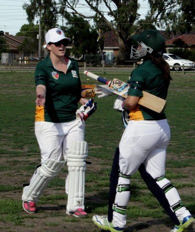 Two women cricketers shake hands