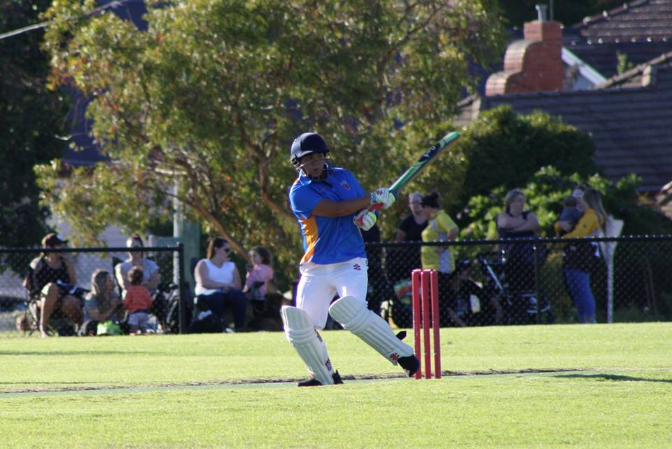 Cricketer hitting ball